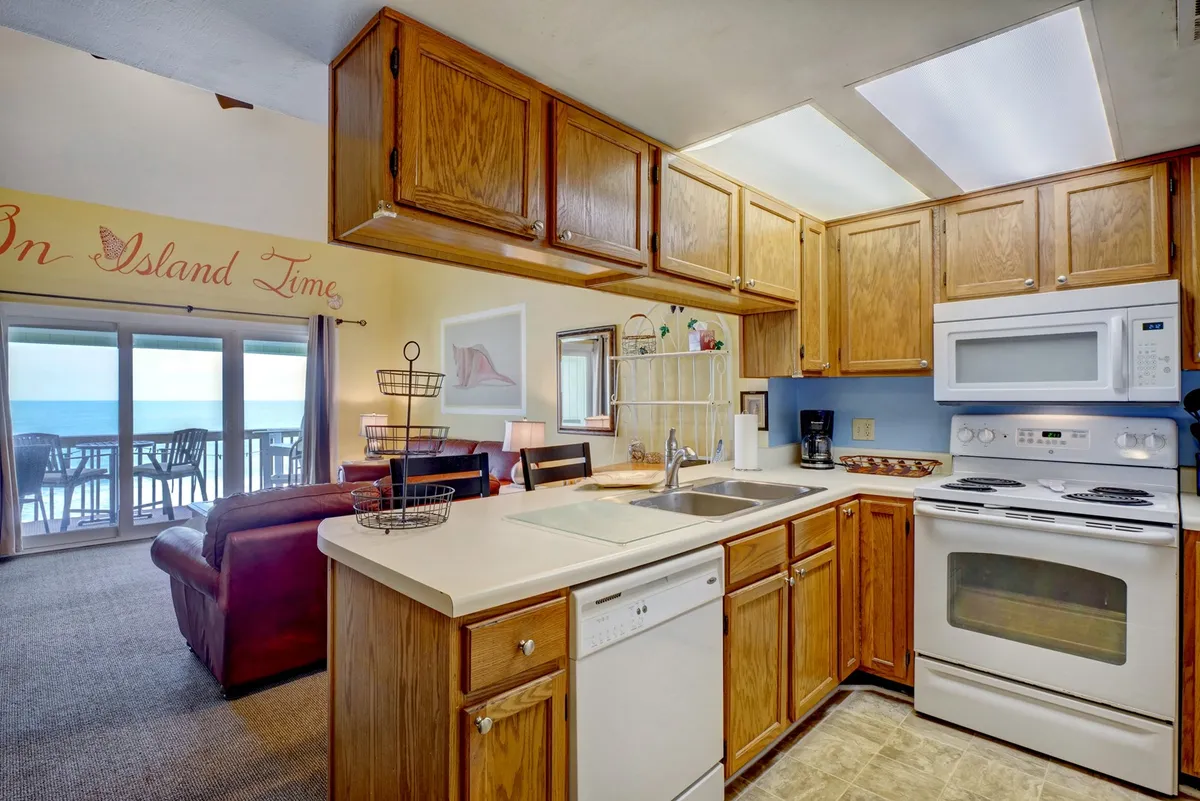 A bright kitchen counter with a sink, modern appliances, and a window that offers a glimpse of the outdoors. The layout encourages both meal preparation and socializing, enhanced by natural light and a relaxing view ideal for morning breakfasts or evening gatherings.